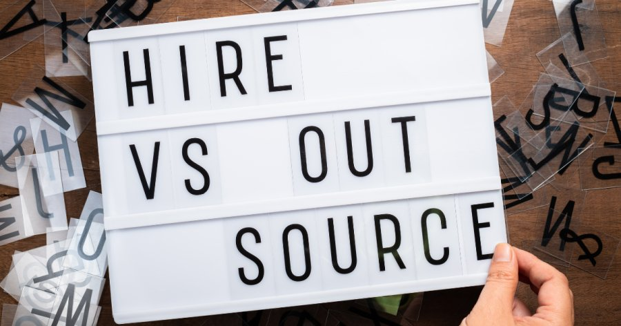 A lightbox showing the words hire or outsource representing the idea to outsource your tender writing